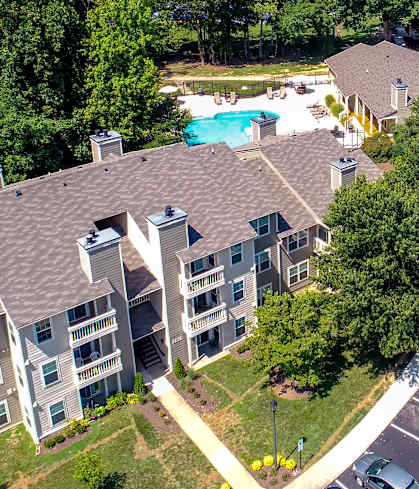 an aerial view of a large apartment complex with a swimming pool and parking lot at Hunters Chase Apartments, Midlothian, VA