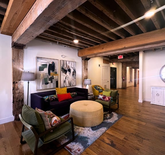 a living room with a couch and chairs in a loft