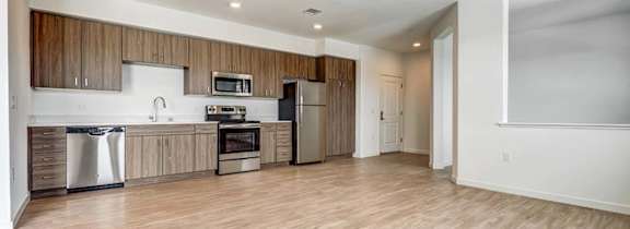 A kitchen with wooden cabinets and a white countertop.