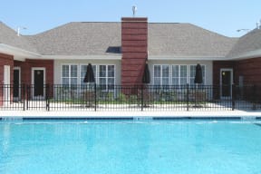 The leasing office with a swimming pool in front of it at Horace Mann apartments and townhomes in Gary, IN