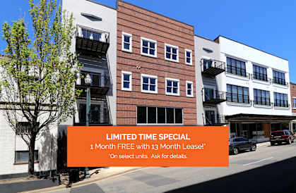 A building with a sign offering a 1 month free with 13 month lease.