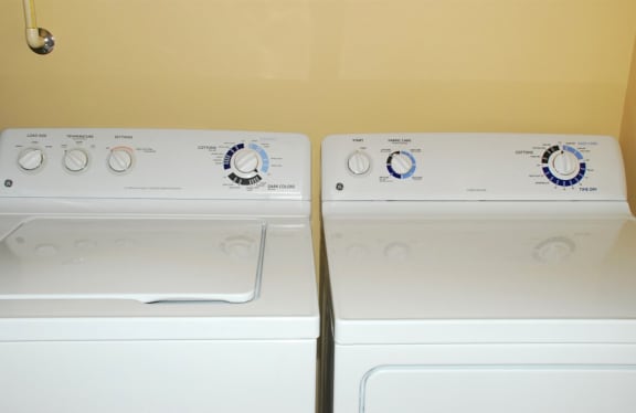 two washes and dryers in the laundry room