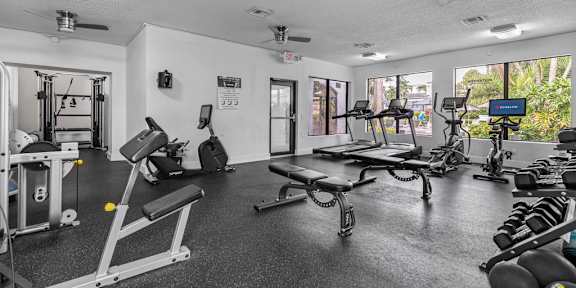 a home gym with weights and cardio equipment