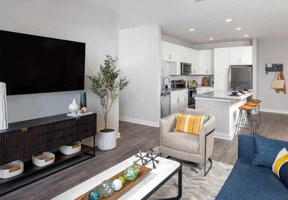 a living room with a couch and a table at Century Mundy Mill Apartments, Oakwood