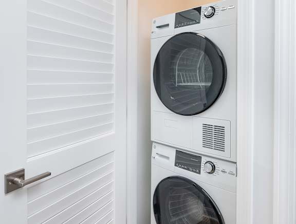 A white washing machine and dryer in a small laundry room.