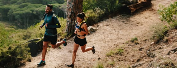 a man and a woman running on a trail at Rivulet, Silverdale Washington