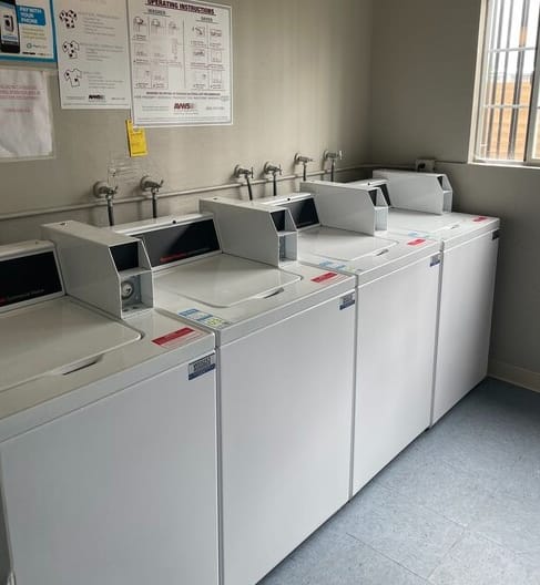 a row of white washing machines sitting next to each other  at Fiesta Apts, California