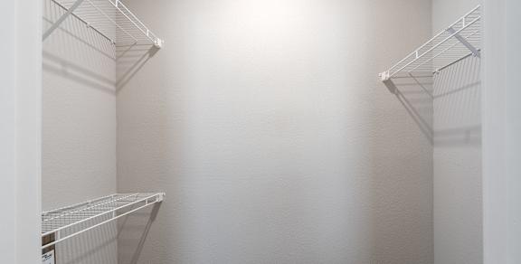 Empty white shelves in a room.