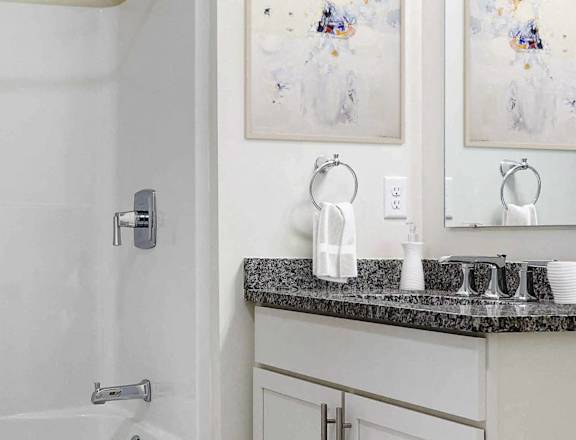 a white bathroom with a shower and a sink