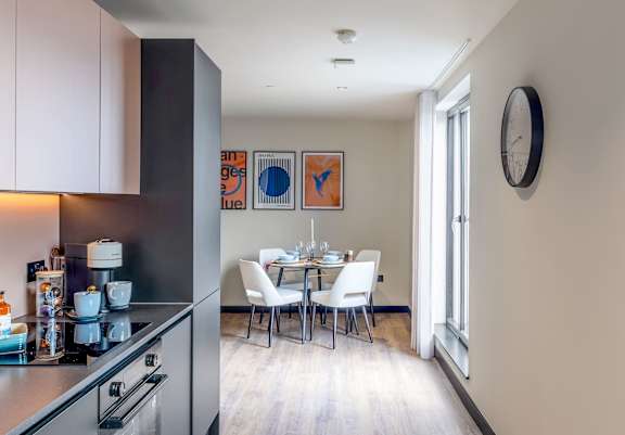 Open plan kitchen and dining area with fitted cabinetry.