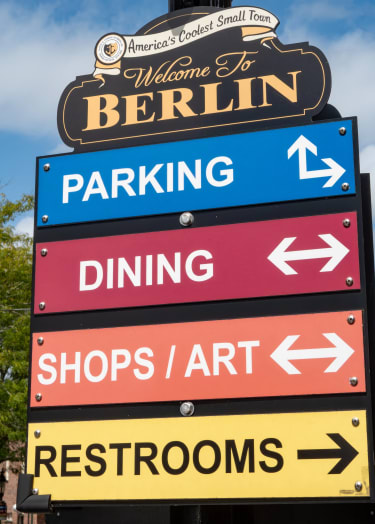 a street sign with many different signs on it