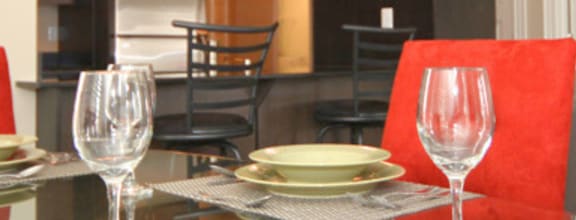 A modern dining room with a wooden table and chairs.
