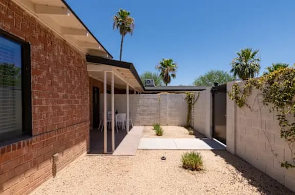A modern house with a patio and a glass door.