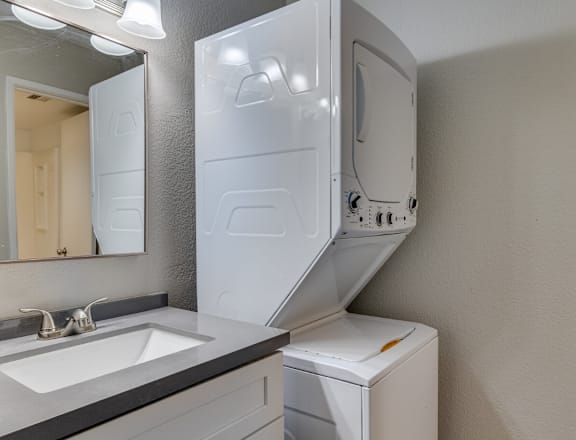 A white dishwasher is placed next to a sink in a modern kitchen.