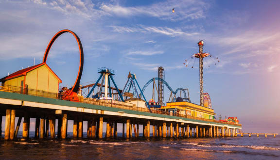 a view of a pier with a roller coaster on it at The Courtyards of Chanticleer, Virginia Beach, VA