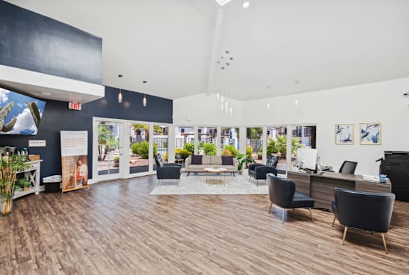 A spacious waiting area with comfortable seating and a view of the outdoors.