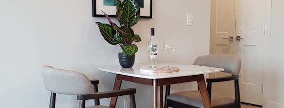 A modern dining room with a wooden table and chairs.