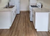 Thumbnail 1 of 7 - an empty kitchen with white cabinets and white appliances