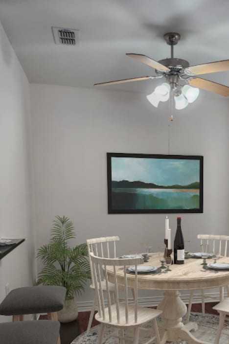 a dining room with a table and chairs and a ceiling fan