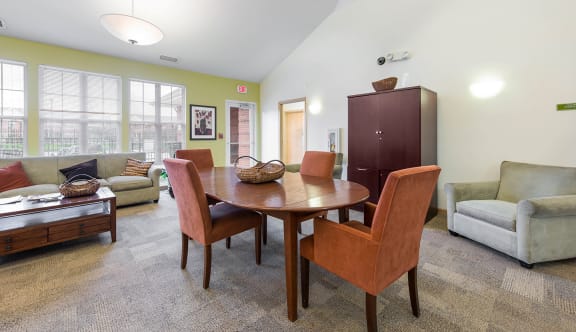 a community room with a table and chairs at Horace mann apartments and Townhomes in Gary, IN