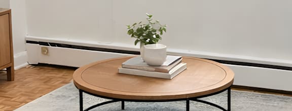 A modern dining room with a wooden table and chairs.