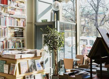 A book store with a white dog hanging from the ceiling.