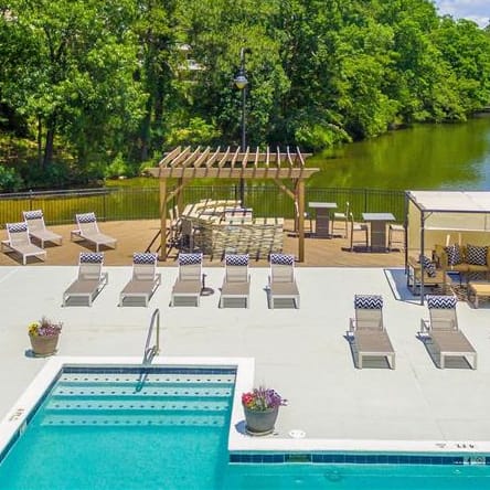 an aerial view of a swimming pool and patio with lounge chairs
