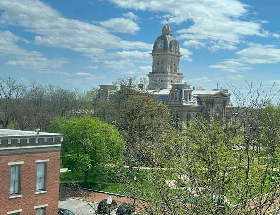 A cityscape with a large building in the background and a church steeple.