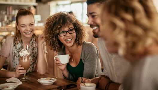 Group of People Smiling while in Coffee Shop