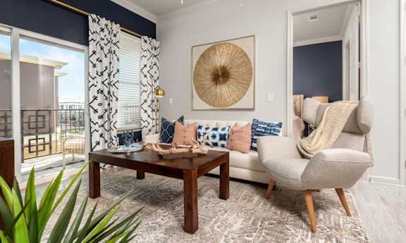 A living room with a wooden coffee table and a beige armchair.