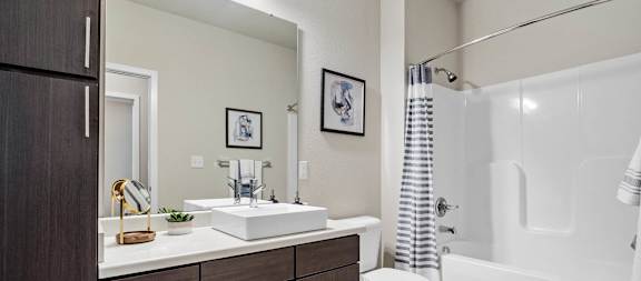 A bathroom with a white sink, toilet, and bathtub at Aventura at Wentzville I & II Apartments, Wentzville, Missouri