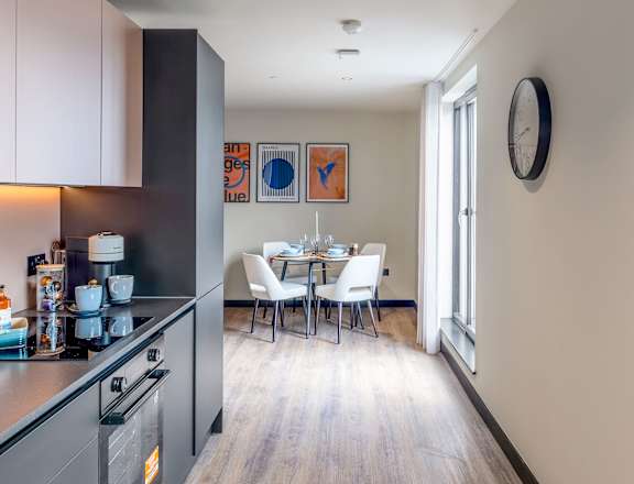 Open plan kitchen and dining area with fitted cabinetry.