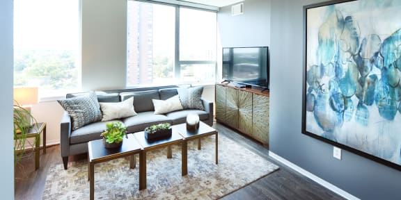 a living room with a couch and a coffee table and a television  at Two Twelve Clayton, Clayton, MO, 63105