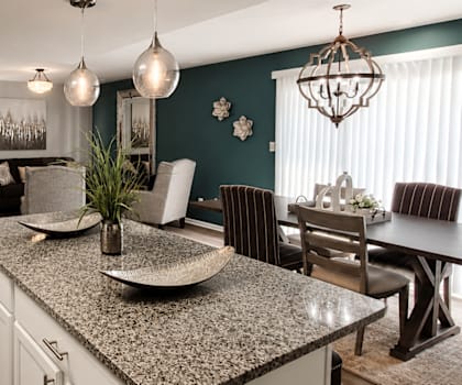 A kitchen with a dining table and chairs.