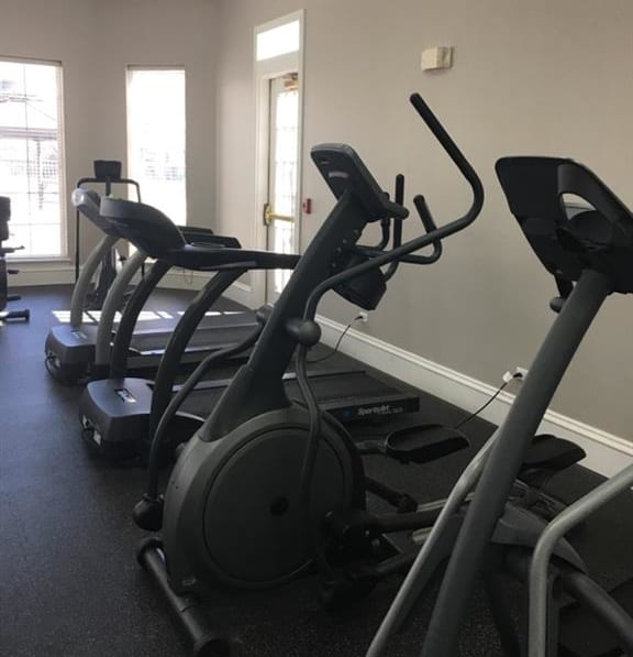 a gym with some exercise equipment in it at Remington Apartment Homes, Romeoville, IL, 60446