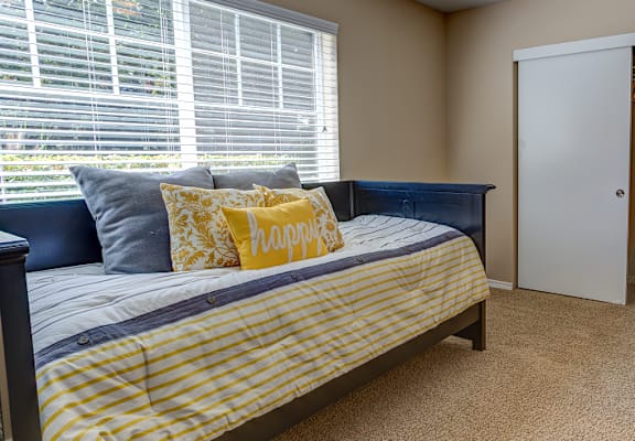 Bedroom with bed and window at Commons at Hawthorn Village Apartments, Hillsboro, 97124
