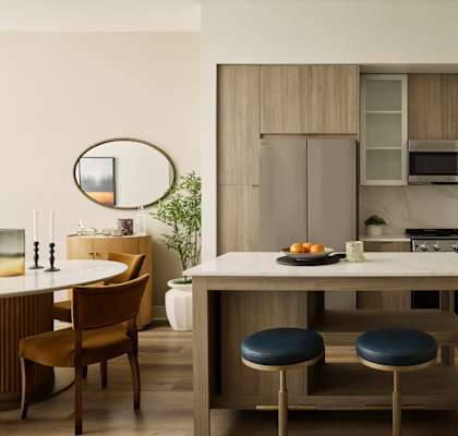 A modern kitchen with a dining table and chairs.