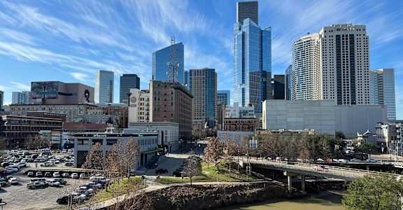 a city skyline with a river in the foreground