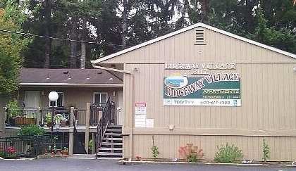 A building with a sign that says "Twinbrook Village" on it.