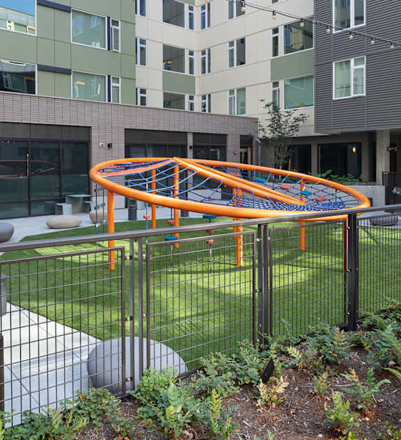 a playground in front of an apartment building at Cedar Crossing, Seattle, WA, 98115