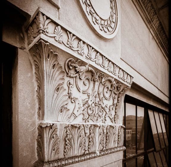 an ornate pillar on the side of a building