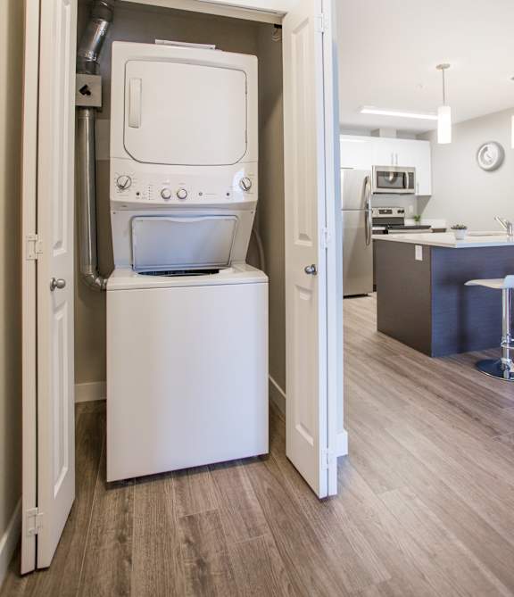 A white dishwasher is open in a kitchen.