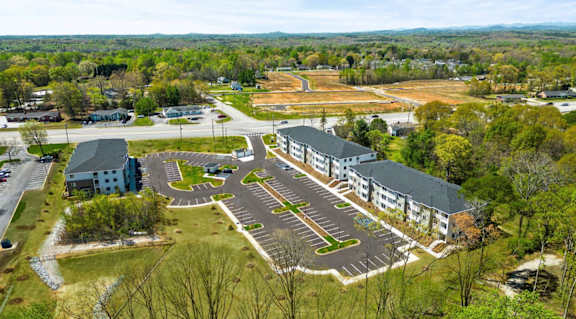 A large building complex with a parking lot in front.