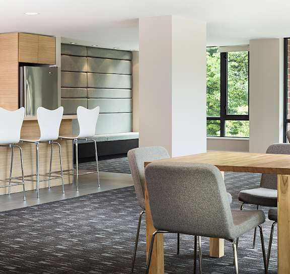a dining room with a table and chairs and a kitchen