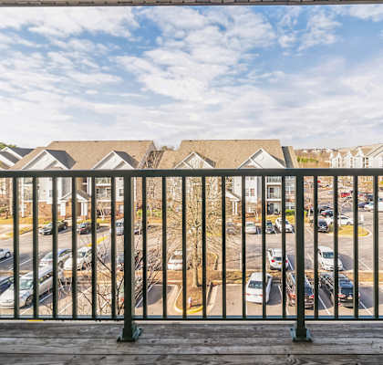 a balcony with a view of a parking lot