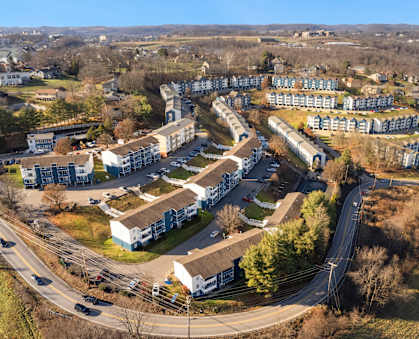 A bird's eye view of a residential area with houses and a road.