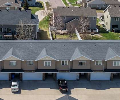 A large residential complex with multiple houses and a parking lot.