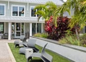 Thumbnail 25 of 58 - a patio with chairs in front of a house at Palm Grove in Ellenton, FL 34222