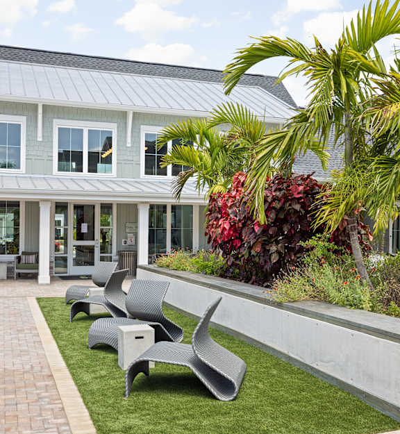 a patio with chairs in front of a house at Palm Grove in Ellenton, FL 34222