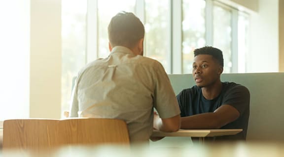 two men sitting at a table